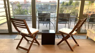 two chairs and a table in front of a window at Beautiful Vilnius with a terrace in Vilnius