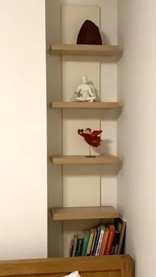 a book shelf with a red bird sitting on it at Beautiful Vilnius with a terrace in Vilnius