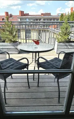 a table and two chairs on a balcony with a table and chairs at Beautiful Vilnius with a terrace in Vilnius