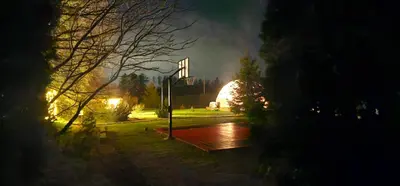 a park at night with a building in the background at 4 Wheels Cabin in Būda