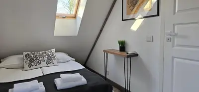 a small bedroom with a bed with towels on it at 4 Wheels Cabin in Būda