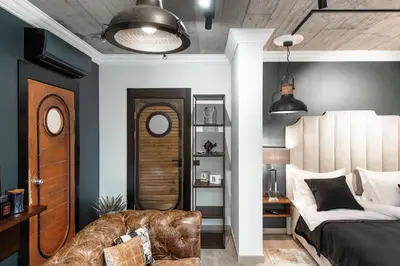 a bedroom with a bed and a couch at Barber Apartment in Kaunas