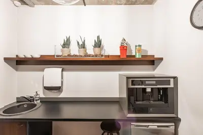 a kitchen with a sink and a microwave at Barber Apartment in Kaunas