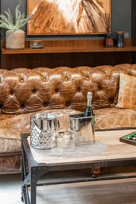 a coffee table with a couch in a living room at Barber Apartment in Kaunas