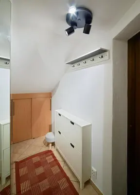 a room with a white wall and a white dresser at Old Town Apartments FREE Parking in Vilnius