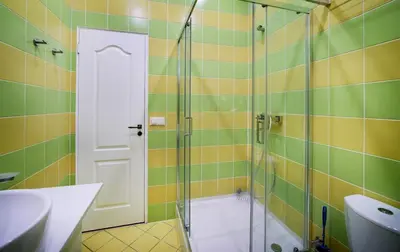 a bathroom with a glass shower with a sink at Old Town Apartments FREE Parking in Vilnius
