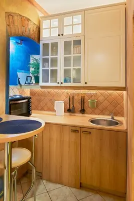 a kitchen with wooden cabinets and a sink at Old Town Apartments FREE Parking in Vilnius