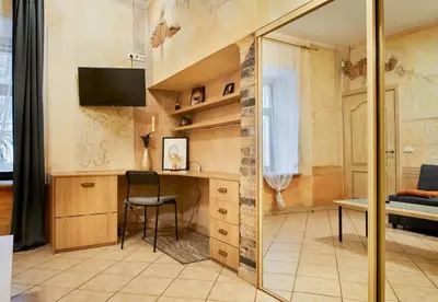 a small room with a desk and a chair at Old Town Apartments FREE Parking in Vilnius