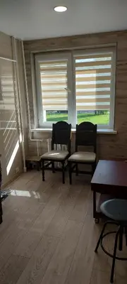 a room with two chairs and two windows at Apartamentai Auris in Druskininkai
