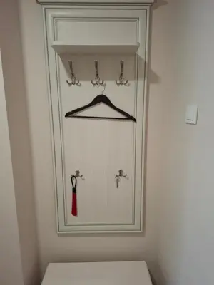 a bathroom with a white cabinet with a red tie at Apartamentai Auris in Druskininkai