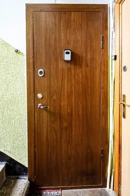 a wooden door with a handle in a room at Hugo apartment in Šiauliai