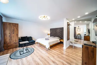 a bedroom with a bed and a couch at Hugo apartment in Šiauliai