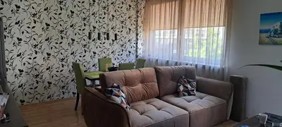 a living room with a couch and a table at Vita apartment in Vilnius