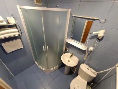 a bathroom with a shower and a toilet and a sink at viešbutis Jurbarkas in Jurbarkas