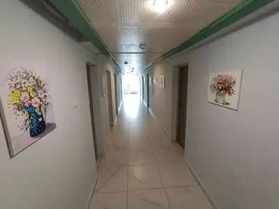 a hallway with two paintings on the walls and a hallway at viešbutis Jurbarkas in Jurbarkas
