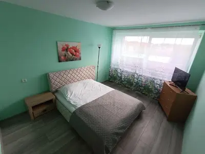 a small bedroom with a bed and a window at viešbutis Jurbarkas in Jurbarkas