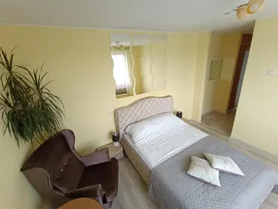 a room with a bed and a chair in it at viešbutis Jurbarkas in Jurbarkas