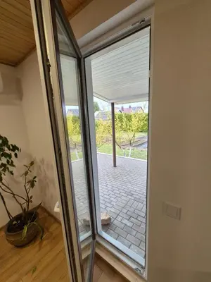 a sliding glass door leading to a patio at Namas Zarasuose su vyno rūsiu in Zarasai