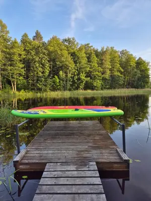 a canoe sitting on top of a dock on a lake at Dariaus ir Gireno 7 in Zarasai