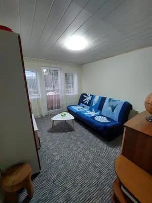 a living room with a couch and a table at Dariaus ir Gireno 7 in Zarasai