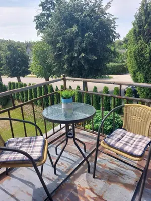 a patio table and two chairs on a balcony at Dariaus ir Gireno 7 in Zarasai