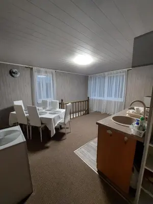 a dining room with a table and chairs and a sink at Dariaus ir Gireno 7 in Zarasai