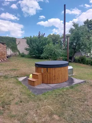 a wooden circle with a table and benches in a field at Dariaus ir Gireno 7 in Zarasai