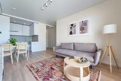 a living room with a couch and a table at Cozy apartment with huge terrace in Vilnius
