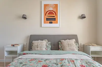 a bedroom with a bed and two night stands at Cozy apartment with huge terrace in Vilnius