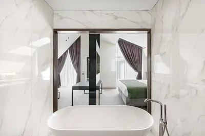 a bathroom with a sink and a bed and a mirror at Harmony Birštonas in Birštonas