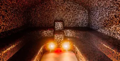 a tunnel with lights in a brick wall at Molėtai Hotel in Molėtai