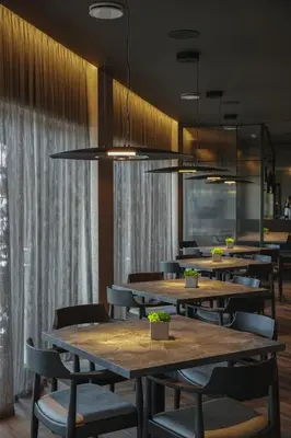 a row of tables and chairs in a restaurant at Molėtai Hotel in Molėtai