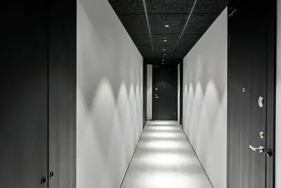 a hallway with a long corridor with lights on the wall at Cozy Japanese Oasis with Balcony, Gramophone, Netflix in Vilnius