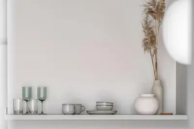 a shelf with a bunch of glass items on it at Cozy Japanese Oasis with Balcony, Gramophone, Netflix in Vilnius
