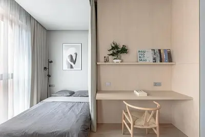 a bedroom with a bed and a desk with a chair at Cozy Japanese Oasis with Balcony, Gramophone, Netflix in Vilnius