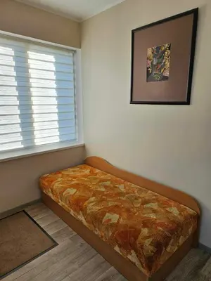a bed in a room with a window at Red Brick House in Naciūnai