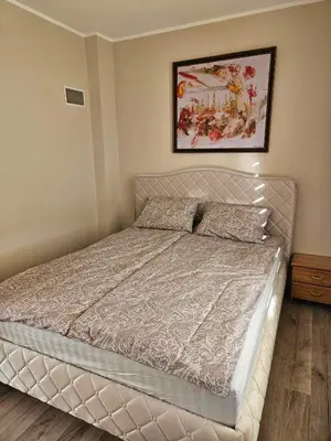 a bed in a bedroom with a picture on the wall at Red Brick House in Naciūnai