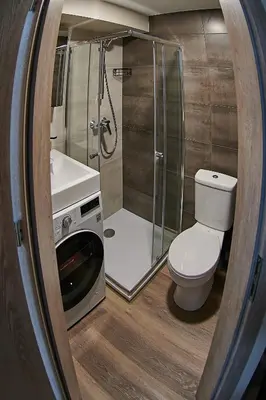 a bathroom with a shower and a toilet and a sink at COZY VISIT, Studio4 with balcony, 24h Self Chek-in, on the first floor in Kaunas