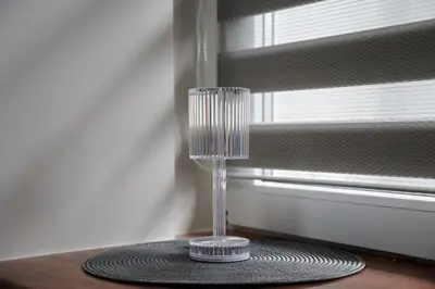 a glass vase sitting on a table next to a window at COZY VISIT, Studio4 with balcony, 24h Self Chek-in, on the first floor in Kaunas