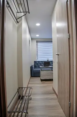 a hallway with a blue couch in a living room at Great location STUDIO1 on the first floor, 24h self check-in in Kaunas