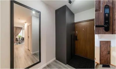 a hallway with a mirror and a door at Grey Apartments in Šiauliai