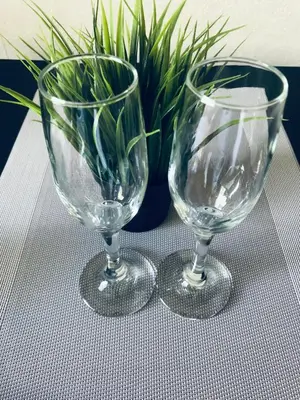 two empty wine glasses sitting on top of a table at COZY Apartment in the SUN CITY in Šiauliai