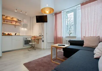 a living room with a couch and a table and a kitchen at ☆ Perfect Spot Apartment ☆ everywhere in 10 min. in Vilnius