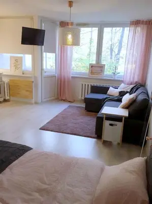 a living room with a couch and a table at ☆ Perfect Spot Apartment ☆ everywhere in 10 min. in Vilnius