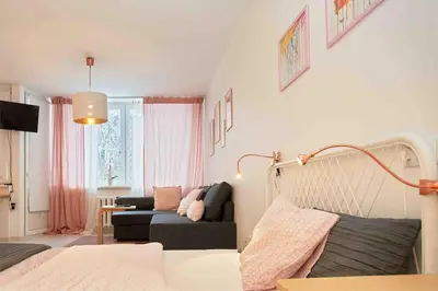 a living room with a bed and a couch at ☆ Perfect Spot Apartment ☆ everywhere in 10 min. in Vilnius