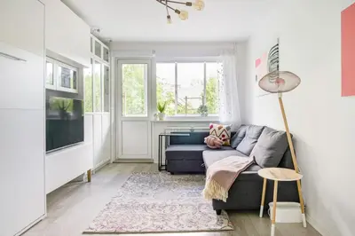 a living room with a couch and a tv at Hidden gem apartment In 10min everywhere in Vilnius