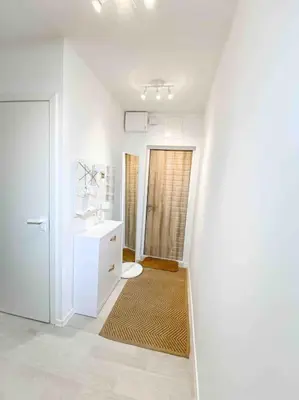 a white bathroom with a sink and a toilet at Hidden gem apartment In 10min everywhere in Vilnius