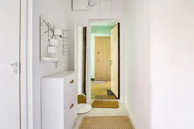 a hallway with a white bathroom with a door at Hidden gem apartment In 10min everywhere in Vilnius