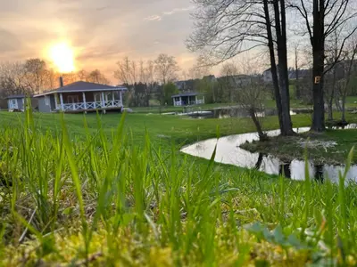 a house in a park with a pond at Žalčio guolis in Lekėčiai