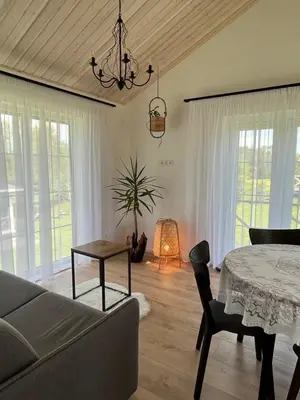 a living room with a couch and a table at Žalčio guolis in Lekėčiai